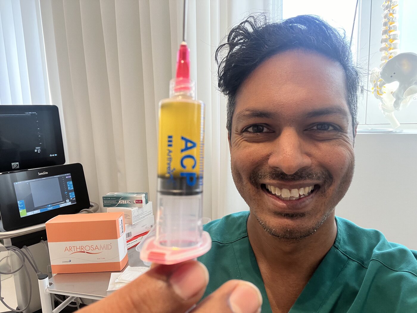 Dr Arj Imbuldeniya holding a high-dose PRP knee injection at Lanserhof at The Arts Club, Mayfair